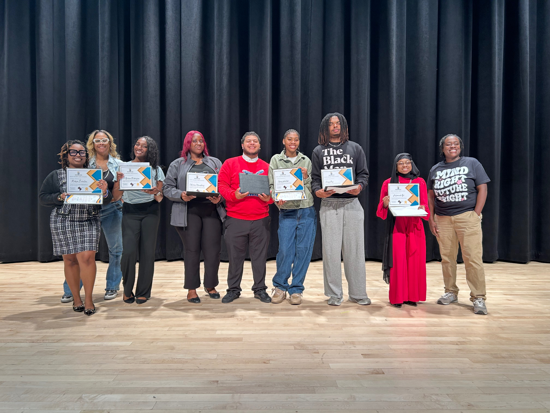 Participant receiving a certificate at a Jus One Academy program
